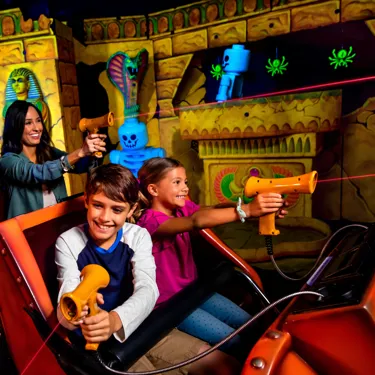 Kids and Mom riding Lost Kingdom Adventure