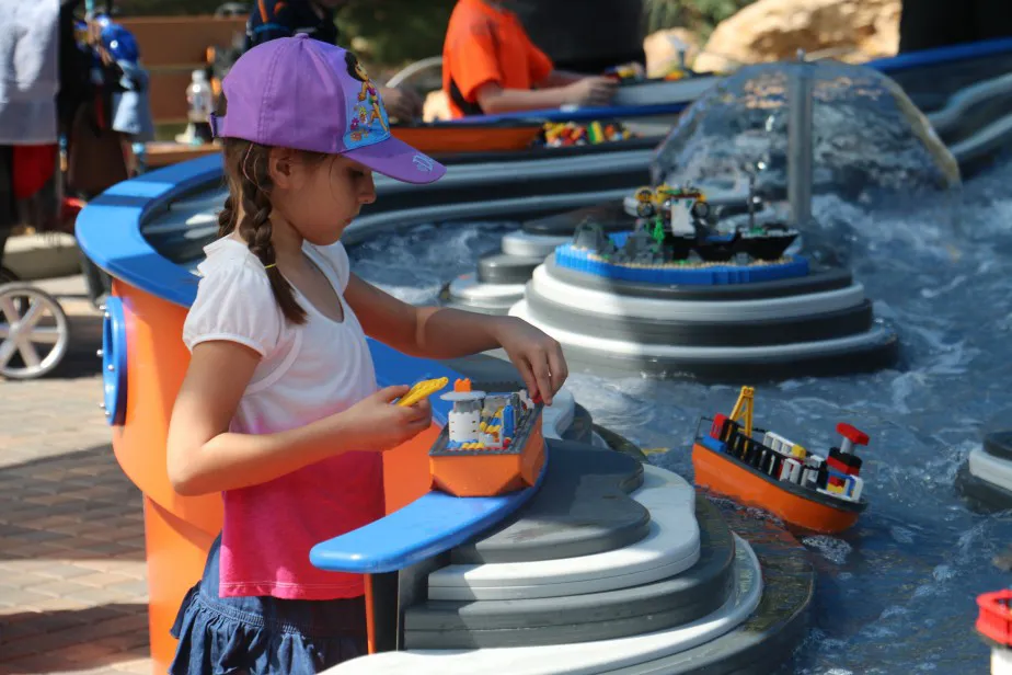 Girl building a LEGO Boat