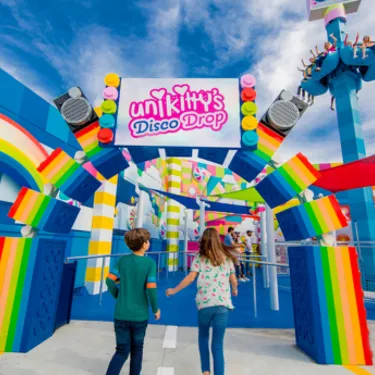 Kids walking through entrance of Unikitty's Disco Drop