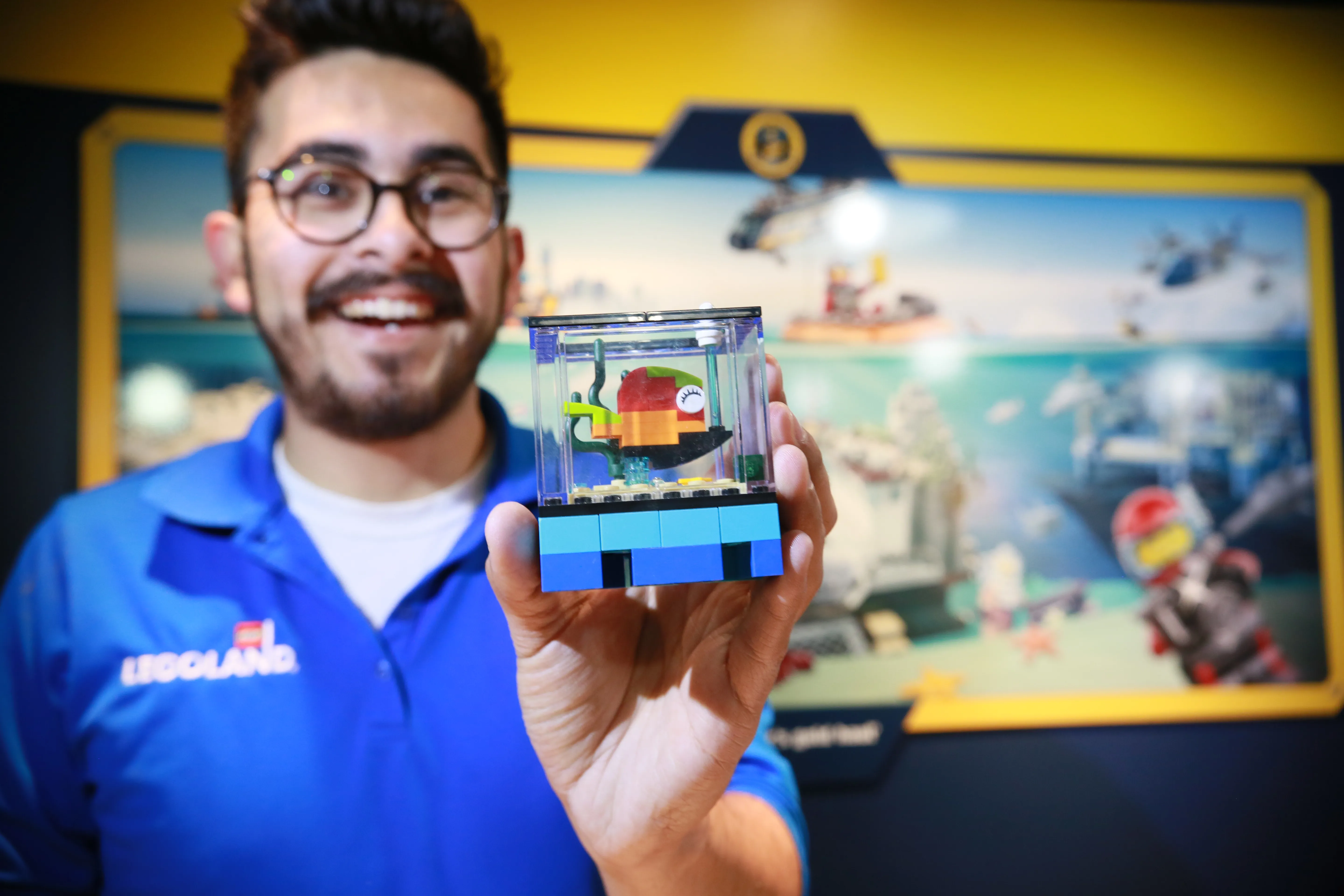 Model Citizen holding LEGO Aquarium